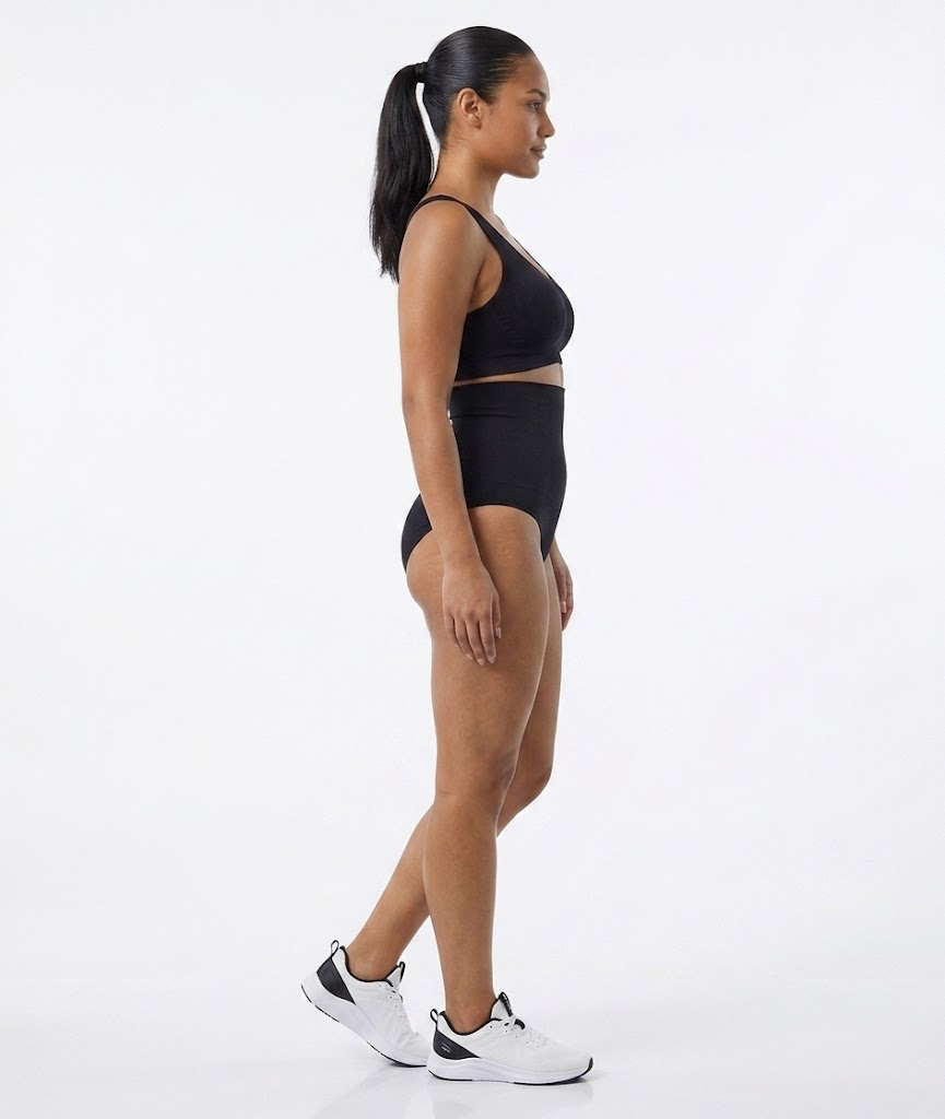Side profile of a model wearing a black bralette and high-waist brief
